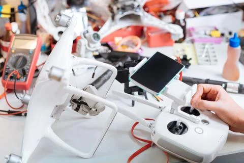 Close up of table and mans hands tuning drone mechanism Stock Photos