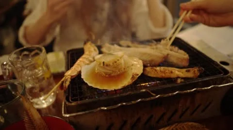 Close up table barbecue, from a Japanese fish barbecue restaurant in Tokyo Stock Footage
