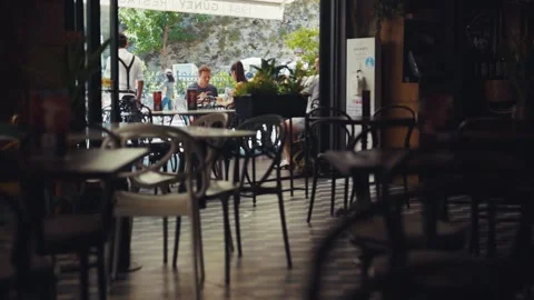 Close up table in cafe on background team waiters in face mask work in cafeteria Video stock 138702501