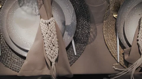 Close-up. Table decor with textured plates and woven napkins outdoors. Decorated Stock Footage 308451211