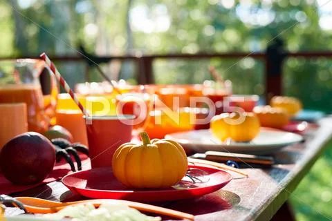 Close-up of table decorated with pumpkins and spiders Stock Photos