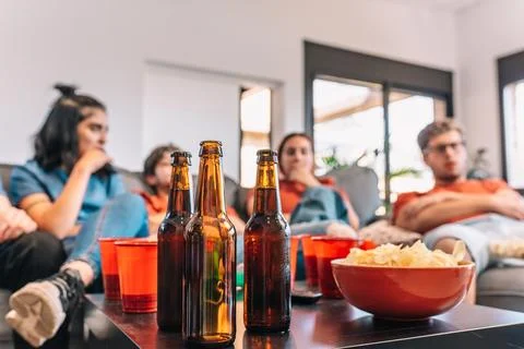 Close-up of a table full of drinks and snacks for a party. Friends watching Stock Photos