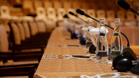 CLOSE UP of table microphones at the world climate change summit, Abu Stock Footage 111900398
