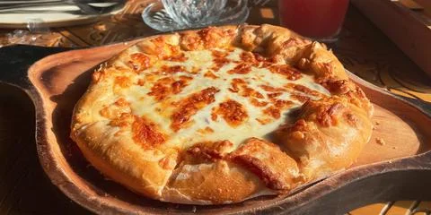 Close-up on a table in a restaurant cooked traditional Georgian dish khachapuri Stock Photos