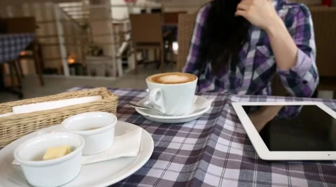 Close up of table in the restaurant. Tablet pc, coffee, bread and butter. Stock Footage 61408268