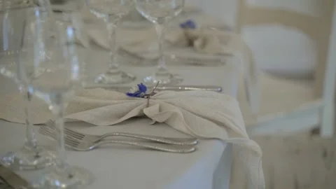 Close-up table setting. Napkins, cutlery and glasses stands on tablecloth. Stock Footage 148651499