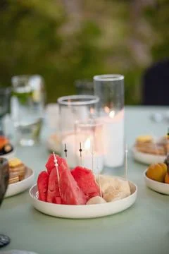Close-up table setting showcasing a plate of fresh watermelon slices and mi.. Stock Photos