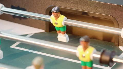 Close up of table soccer game miniatur football yellow brasil player miss the Stock Footage