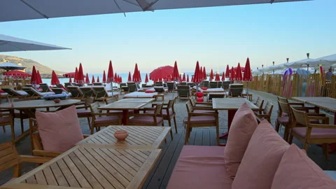 Close up of tables at a restaurant on the beach in the evening Stock Footage 301879234