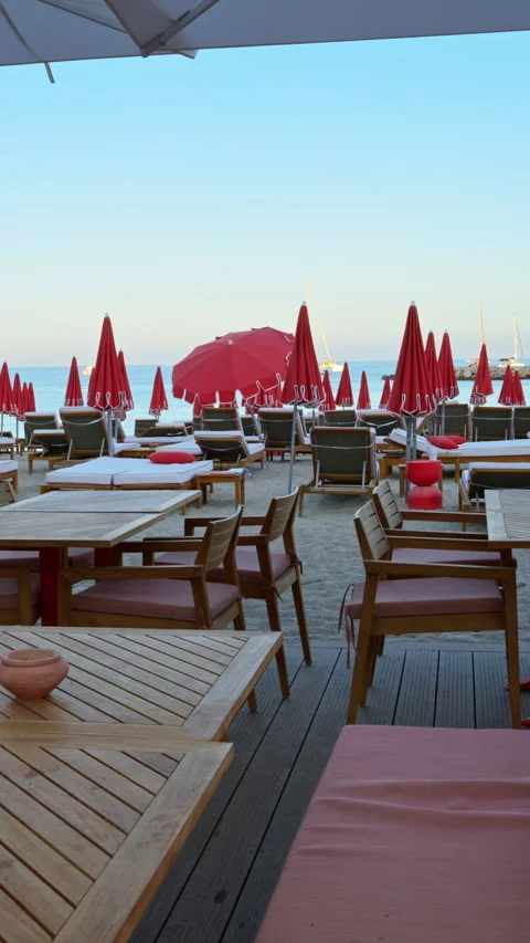 Close up of tables at a restaurant on the beach in the evening. Vertical Stock Footage 301894030