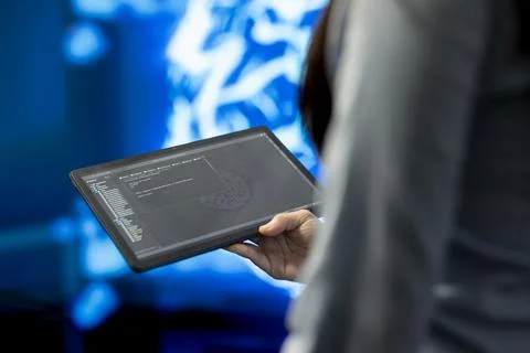 Close up of tablet with AI source code used by researcher Stock Photos