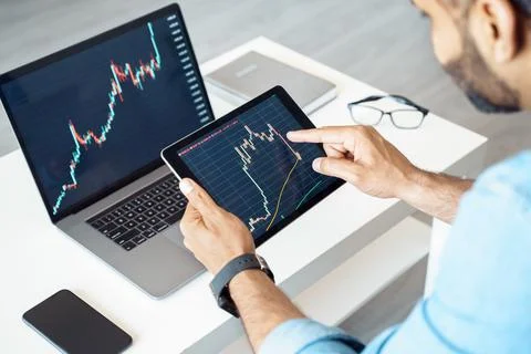Close-up of tablet computer with graphs, diagrams and charts on screen in hands Stock Photos