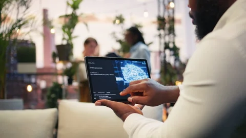 Close up of tablet displaying AI brain during rooftop business presentation Stock Footage 345165888