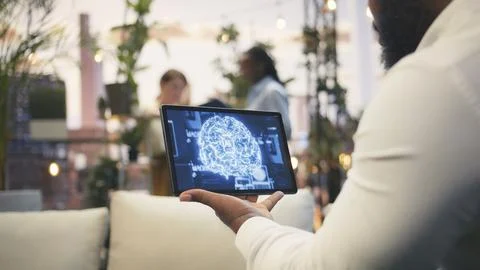 Close up of tablet displaying AI brain during rooftop business presentation Stock Photos