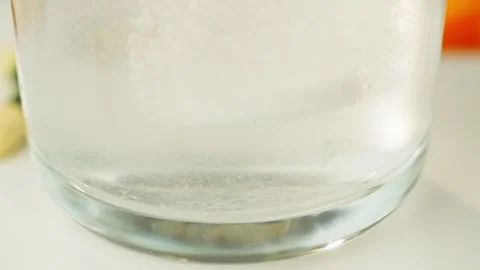 Close-up of a tablet dissolving in water. Treatment and medicine taking pills. Stock Footage 277999738
