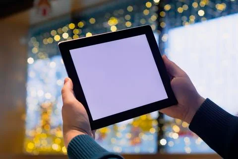 Close-up Tablet mockup with white screen. A male freelancer works in a cafe. Stock Photos