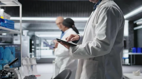 Close up of tablet with modern laboratory software used by scientist Stock Footage 318424208