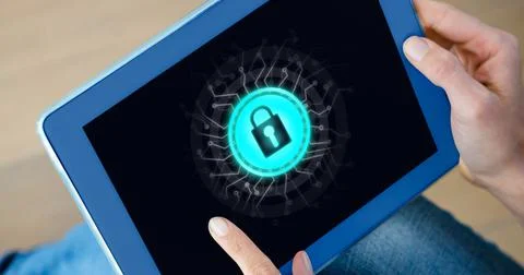 Close up of tablet with padlock graphic on screen, held by caucasian woman Stockfoto's