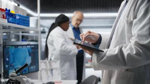 Close up of tablet running important experiment data in a research lab Stock Photos
