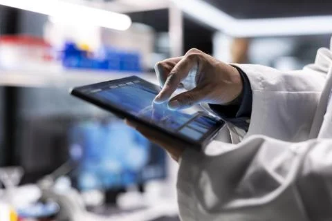 Close up of tablet running laboratory experiments in chemistry and biology Stock Photos