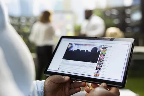 Close up of tablet running live video of concert online on streaming platform Stock Photos