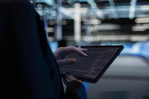 Close up of tablet used by data center computer scientist to write code 写真素材