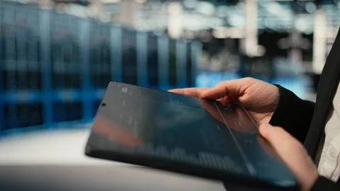 Close up of tablet used by data center admin troubleshooting supercomputers Stock Photos