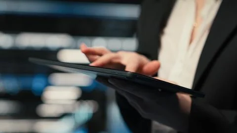 Close up of tablet used by data center admin troubleshooting supercomputers Stock Photos