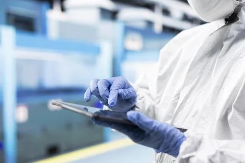 Close up of tablet used by tech specialist in PCB factory cleanroom Stock Photos