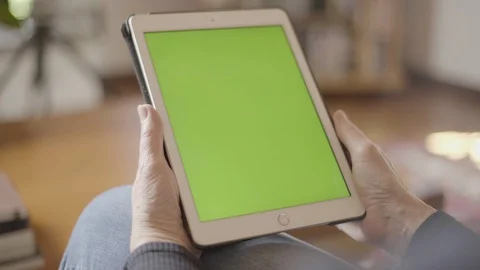 Close up of Tablet in woman's hands with green screen frame, relaxing on couch Stock Footage 130137874