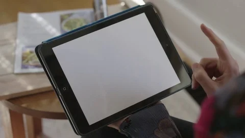 Close up of tablet as young lady points and holds Stock Footage 70809007