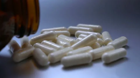 Close-up, tablets in capsules lie on a blue background. Stock Footage 149297663