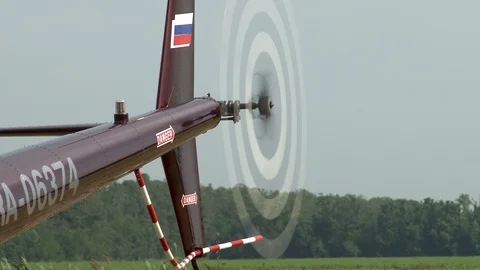 Close-up of tail boom of Robinson R44 helicopter with rotating tail rotor. Stock Footage 105843384