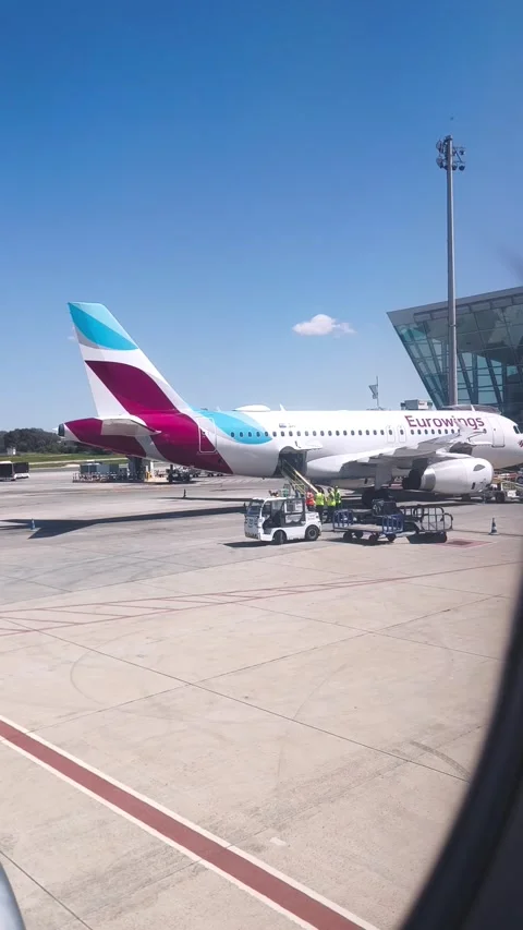 A close-up of the tail section of a Eurowings aircraft at the airport. View from Stock Footage 322550361