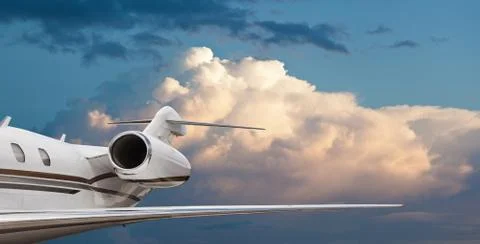 Close tail side view of a private jet flying Stock Photos