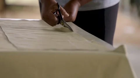 Close Up Of Tailor Cutting Fabric With Scissors Stock Footage 336427139