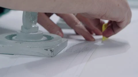 Close up tailor Hands with soap or chalk Making a Pattern sketch on paper before Video stock 131064314