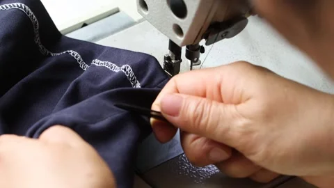 Close-up of Tailor Hands Using Industrial Sewing Machine for Textile Production Stock Footage 340206926