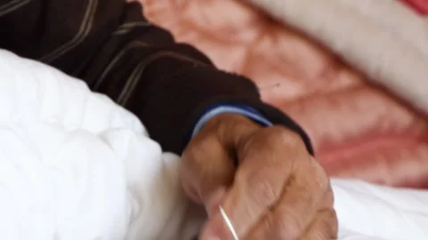 Close-up of a tailor sewing a quilt in the workshop Stock Footage 243729857
