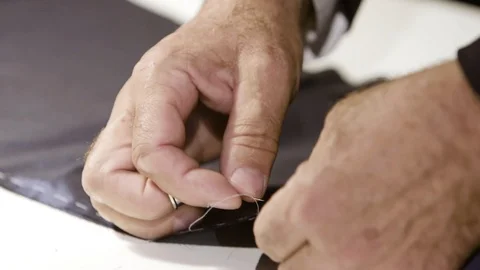 Close up of a tailor's hands using a thimble. Tailor's tacks, basic sewing Stock Footage 127040039