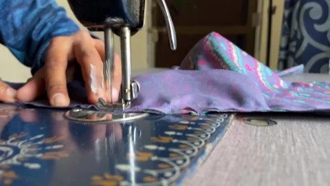 Close up of a tailor's hands using a vintage sewing machine Stock Footage 328398575