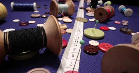 Close up of a tailor's work desk with tailoring tools, pins, buttons. Stock Footage 168251493