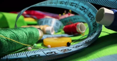 Close up of a tailor's work desk with tailoring tools, pins, buttons, sewing Stock Footage 168373087