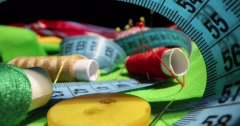 Close up of a tailor's work desk with tailoring tools, pins, buttons, sewing Stock-Footage 168373210