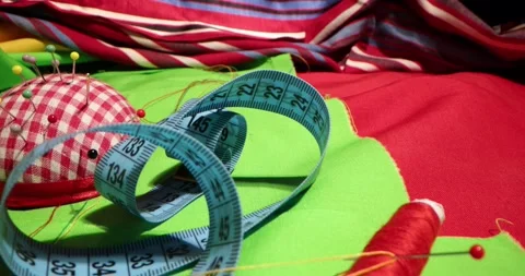 Close up of a tailor's work desk with tailoring tools, pins, buttons, sewing Stock Footage 168373335