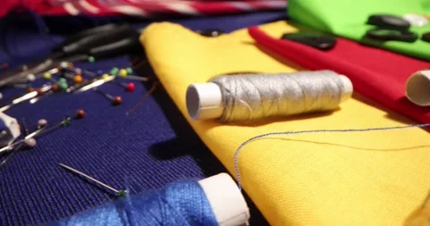 Close up of a tailor's work desk with tailoring tools, pins, buttons, sewing Stock Footage 168373436