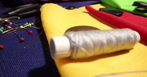 Close up of a tailor's work desk with tailoring tools, pins, buttons, sewing Stock Footage 168373521
