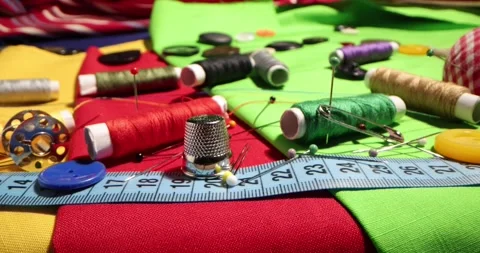 Close up of a tailor's work desk with tailoring tools, pins, buttons, sewing Stock Footage 168373654