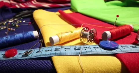 Close up of a tailor's work desk with tailoring tools, pins, buttons, sewing Stock Footage 168373755