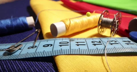 Close up of a tailor's work desk with tailoring tools, pins, buttons, sewing Stock Footage 168373873
